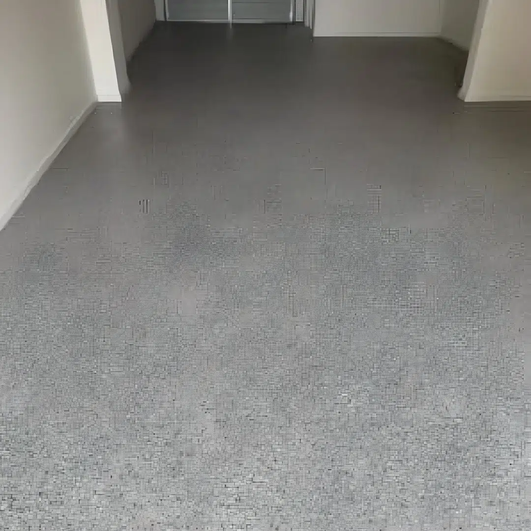 Freshly coated epoxy garage floor with a clean speckled finish