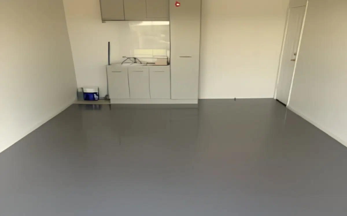 Freshly coated gray epoxy garage floor with a clean polished finish