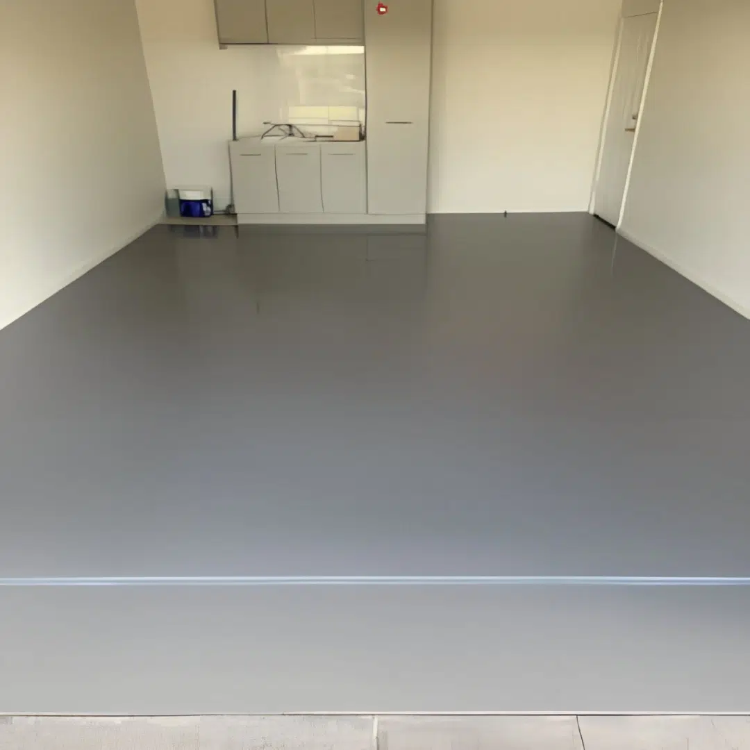 Freshly coated gray epoxy garage floor with a clean polished finish