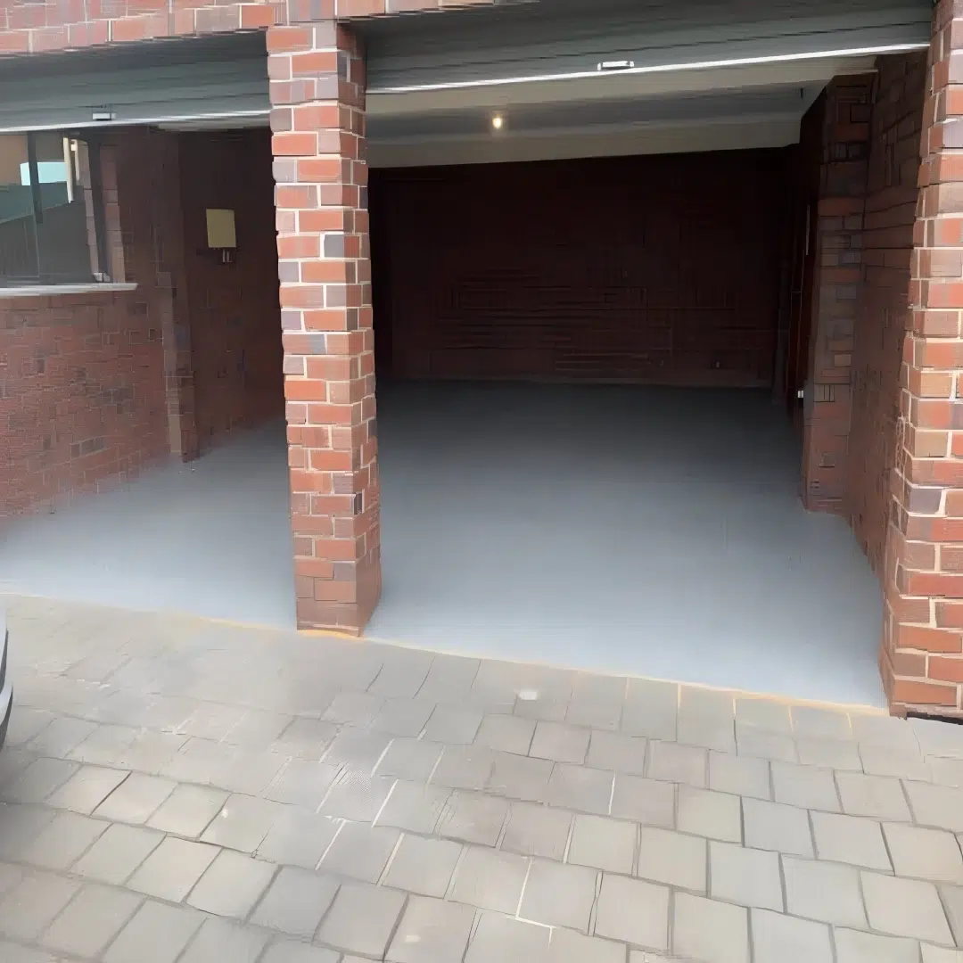 Freshly finished clean epoxy coated garage floor ready for its first parked car